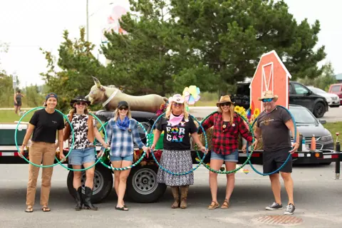 A group with hula hoops at the Pride parade, 2024