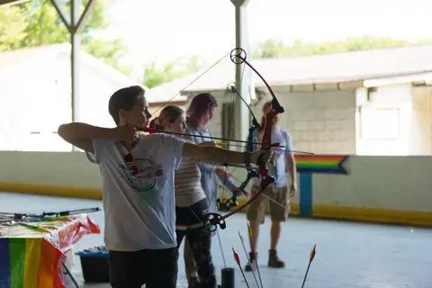 Archery with Rainbow Hood at Pride Manitoulin, 2024