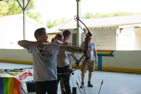 Archery with Rainbow Hood at Pride Manitoulin, 2024