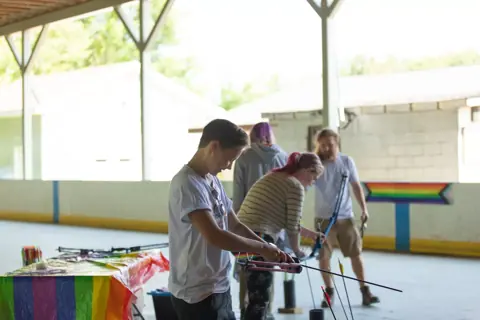 Archery with Rainbow Hood at Pride Manitoulin, 2024
