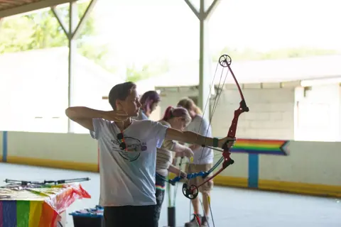 Archery with Rainbow Hood at Pride Manitoulin, 2024