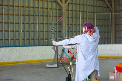 Archery with Rainbow Hood at Pride Manitoulin, 2024
