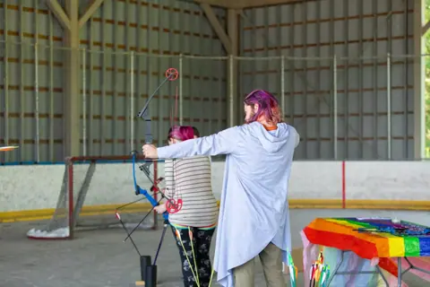 Archery with Rainbow Hood at Pride Manitoulin, 2024