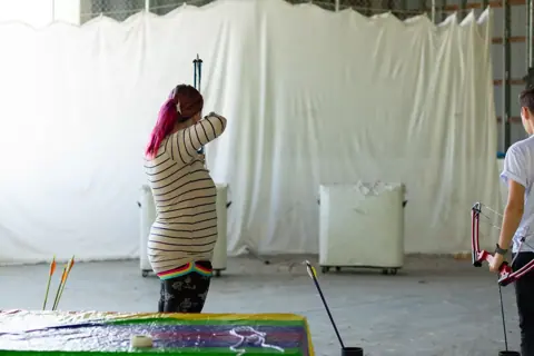 Archery with Rainbow Hood at Pride Manitoulin, 2024