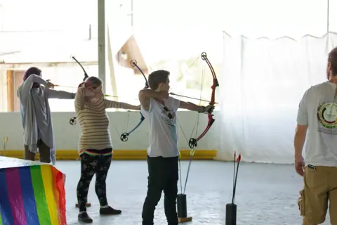 Archery with Rainbow Hood at Pride Manitoulin, 2024