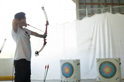 Archery with Rainbow Hood at Pride Manitoulin, 2024
