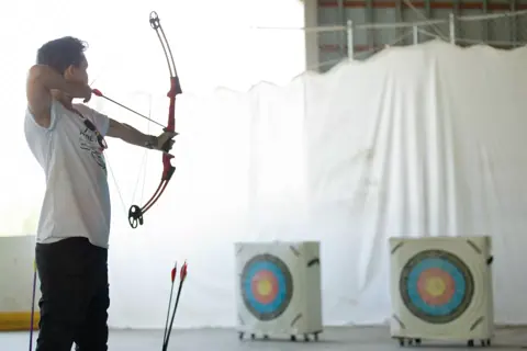 Archery with Rainbow Hood at Pride Manitoulin, 2024